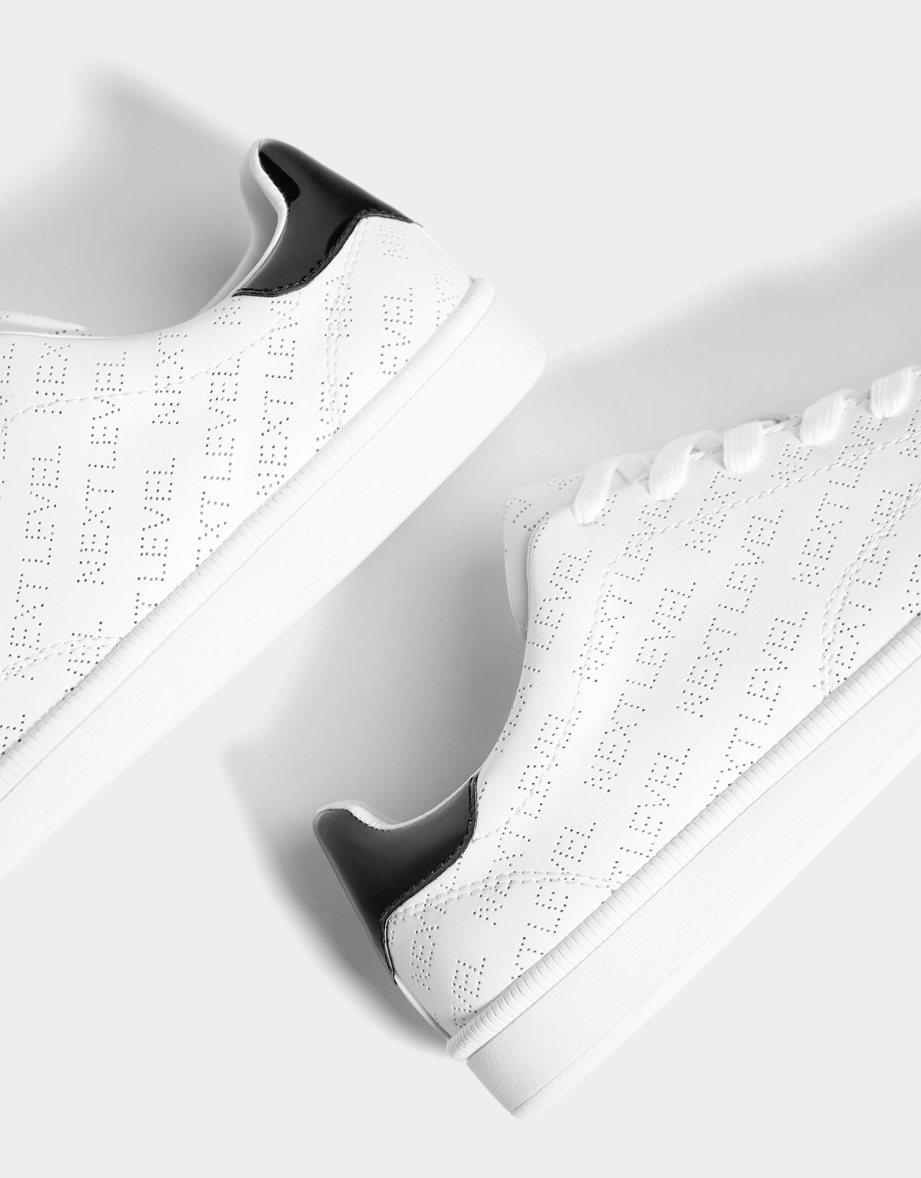 Trainers with broguing slogan