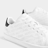 Trainers with broguing slogan