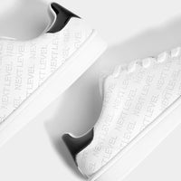 Trainers with broguing slogan